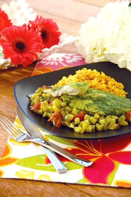 Cilantro tilapia served over golden rice with vegetables